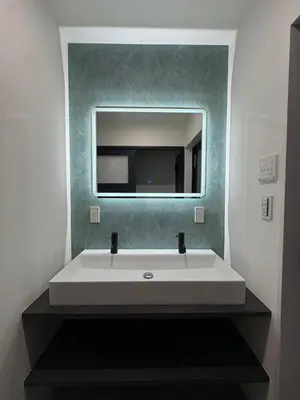 a bathroom with a white sink and a mirror at COTO Premium Kyodo in Tokyo