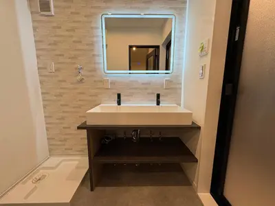 a bathroom with a white sink and a mirror at COTO Premium Kyodo in Tokyo