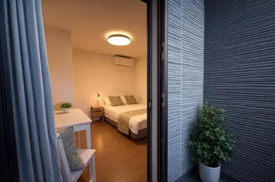 a small room with a bed and a table with a plant at louis stage \u897f\u30f6\u539f 103\u5ba4 in Tokyo