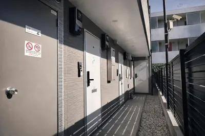 an empty hallway of a building with white doors at louis stage \u897f\u30f6\u539f 303\u5ba4 in Tokyo