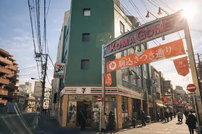 a street with people walking on the sidewalk in front of a building at louis stage \u897f\u30f6\u539f 303\u5ba4 in Tokyo