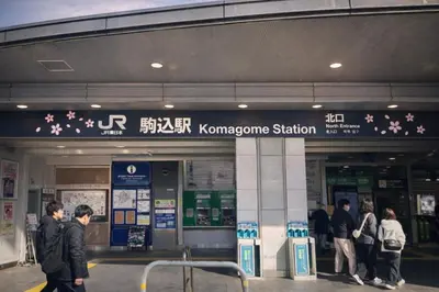 a group of people standing outside of a korean station at louis stage \u897f\u30f6\u539f 303\u5ba4 in Tokyo
