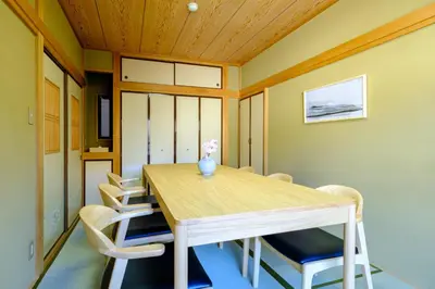 a dining room with a wooden table and chairs at F-City \u4e2d\u845b\u897f iii in Tokyo