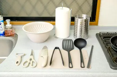 a kitchen counter with utensils on a counter top at F-City \u4e2d\u845b\u897f iii in Tokyo