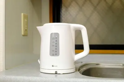 a white pitcher sitting on a counter next to a sink at F-City \u4e2d\u845b\u897f iii in Tokyo