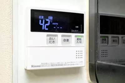 a machine with a clock on it next to a microwave at F-City \u4e2d\u845b\u897f iii in Tokyo