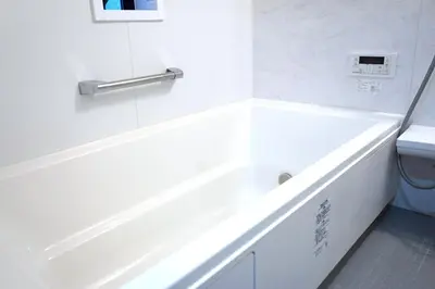 a white bathroom with a tub and a toilet at Private Hotel Skytree Garden in Tokyo