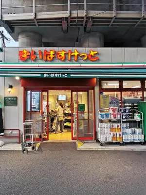 a store front of a store with a man walking into it at Private Hotel Skytree Garden in Tokyo