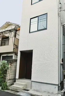 a white brick building with a large door at Private Hotel Skytree Garden in Tokyo