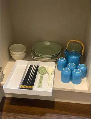 a table with blue cups and utensils on it at Nexus Vill Morishita in Tokyo