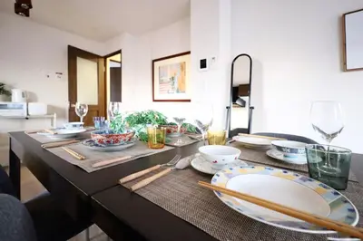 a table with plates and chopsticks on top of it at \u30a8\u30de\u30fc\u30ec\u6771\u5c0f\u5ca9301 \u5c0f\u5ca9\u99c5\u5f92\u6b695\u5206 \u6700\u59275\u540d \u548c\u5ba4\u7573 in Tokyo