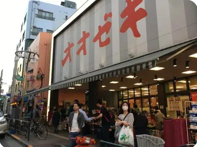 a group of people walking in front of a store at \u677e\u30ce\u7af9101 in Tokyo