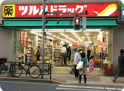 a group of people walking in front of a store at \u677e\u30ce\u7af9101 in Tokyo