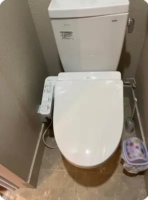 a white toilet in a bathroom with a remote control at \u677e\u30ce\u7af9101 in Tokyo