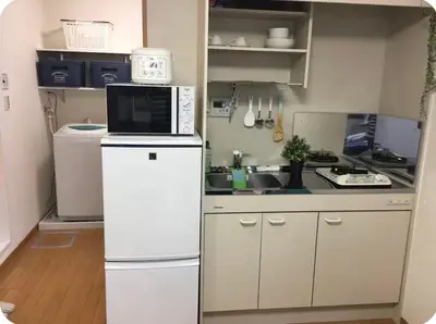 a kitchen with a white refrigerator and a microwave at \u677e\u4e43\u7af9102 in Tokyo