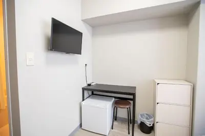 a room with a desk and a tv on the wall at Asakusabashi MY Hostel max2 people-TT0495 in Tokyo