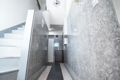 a hallway with a stone wall and stairs at Asakusabashi MY Hostel max2 people-TT0495 in Tokyo