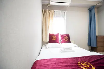 a bedroom with a bed with red pillows and a window at Asakusabashi MY Hostel max2 people-TT0495 in Tokyo