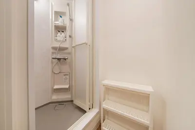 a small white refrigerator with its door open at Hikihune Stay in Tokyo