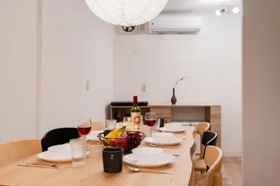 a dining room table with glasses of wine at Hikihune Stay in Tokyo