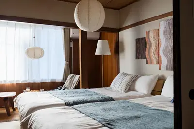 two beds sitting next to each other in a bedroom at Hikihune Stay in Tokyo