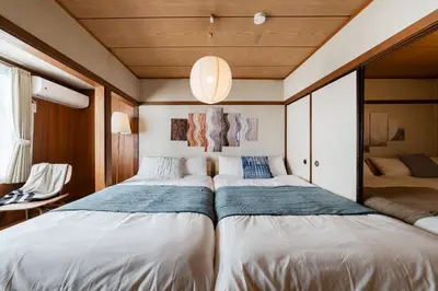 a bedroom with two beds in a room at Hikihune Stay in Tokyo