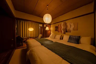 a hotel room with two beds in a bedroom at Hikihune Stay in Tokyo