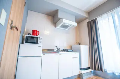 a small kitchen with a refrigerator and a microwave at Asakusabashi MY Hostel-max3 people-TT0509 in Tokyo