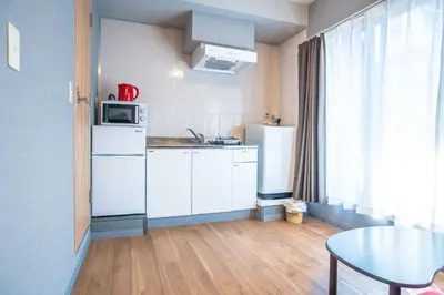 a small kitchen with white appliances and a table at Asakusabashi MY Hostel-max3 people-TT0509 in Tokyo