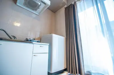 a kitchen with a small refrigerator and a window at Asakusabashi MY Hostel-max3 people-TT0509 in Tokyo
