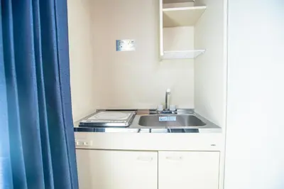 a small kitchen with a sink and a blue curtain at Asakusabashi MY Hostel-max3 people-TT0509 in Tokyo