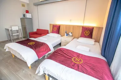 a room with two beds and a red chair at Asakusabashi MY Hostel-max3 people-TT0509 in Tokyo