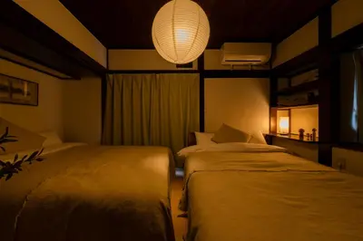 a bedroom with two beds and a chandelier at Higashimukoujima Stay in Tokyo