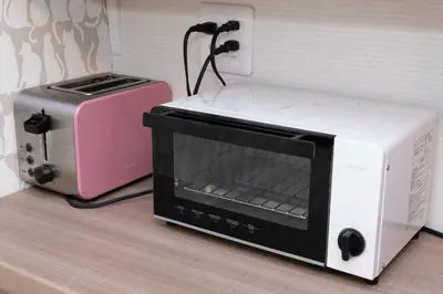 a microwave and a toaster oven sitting on a counter at Shinjuku Private Family House in Tokyo