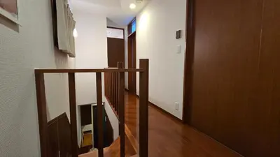 a hallway with a wooden railing and a stair case at Nakano OSHIYO House in Tokyo