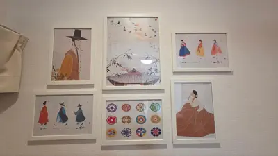 a wall with pictures of women on a wall at Nakano OSHIYO House in Tokyo