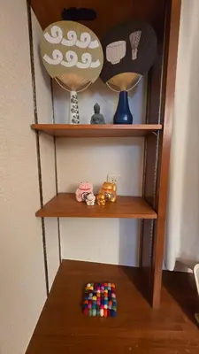 a wooden shelf with some toys on it at Nakano OSHIYO House in Tokyo