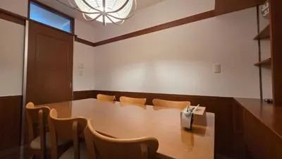 a conference room with a wooden table and chairs at Nakano OSHIYO House in Tokyo