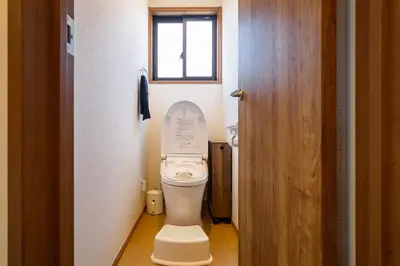 a small bathroom with a toilet with the lid up at Chill Place 120 Ayase in Tokyo
