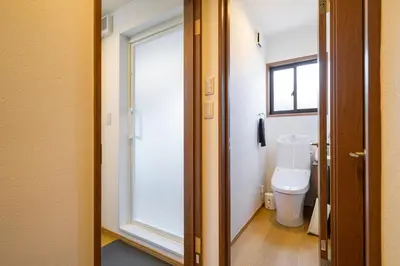 a bathroom with a toilet and a window at Chill Place 120 Ayase in Tokyo