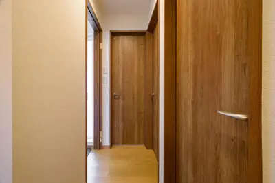 an empty hallway with a wooden door and a hallway at Chill Place 120 Ayase in Tokyo