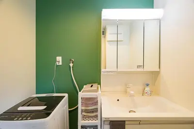a small bathroom with a sink and a mirror at Chill Place 120 Ayase in Tokyo
