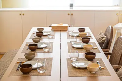 a long table with plates and glasses on it at Penthouse Ueno in Tokyo