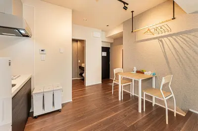 a kitchen and dining room with a table and chairs at Cocono Apartment Hotel in Tokyo