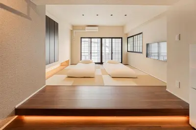 a living room with two pillows on the floor at Cocono Apartment Hotel in Tokyo