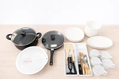 a table with a frying pan and plates and utensils at 1200IN&OUT 5people 35m2 2Queenbed! 1sofabed! Exclusive house Shinjuku 18 minutes Shibuya 22 minutesIkebukuro 11 minutes in Tokyo