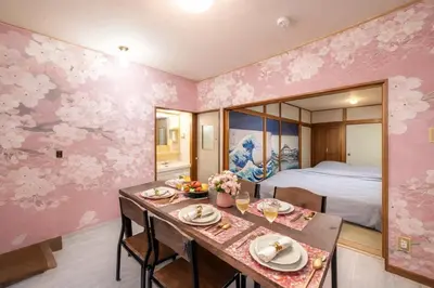 a dining room with a table and a bedroom at 1200IN&OUT 5people 35m2 2Queenbed! 1sofabed! Exclusive house Shinjuku 18 minutes Shibuya 22 minutesIkebukuro 11 minutes in Tokyo