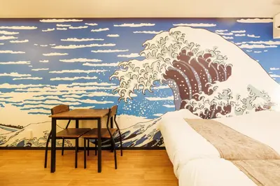 a room with a mural of a wave at WhiteCourt206 in Tokyo