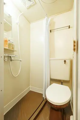 a bathroom with a toilet and a shower at WhiteCourt206 in Tokyo