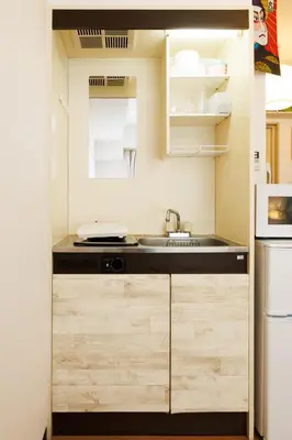 a small kitchen with a sink and a stove at WhiteCourt206 in Tokyo